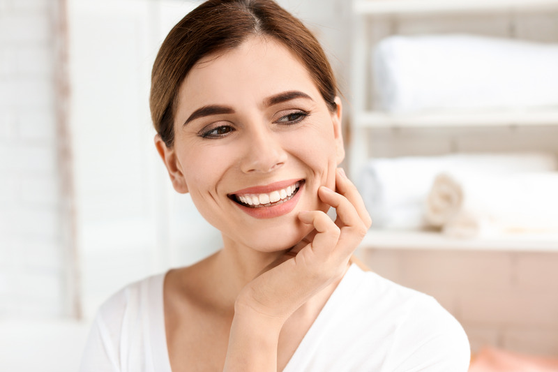 Patient smiling with their porcelain veneers